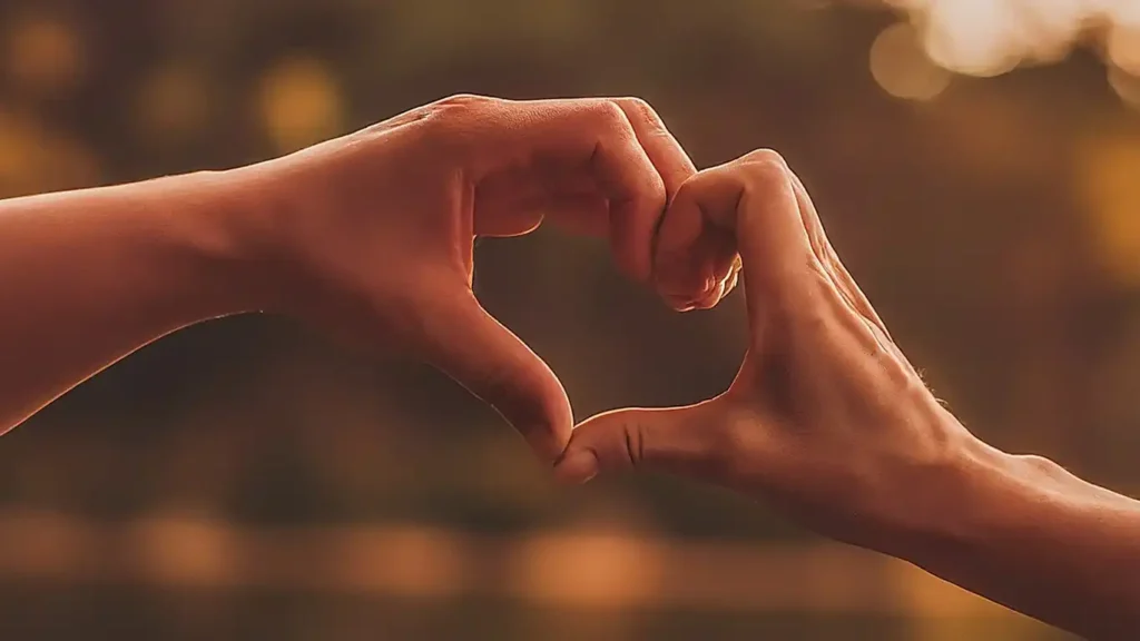 A close-up of hands touching or an embrace, symbolizing the importance of non-penetrative touch and affection.