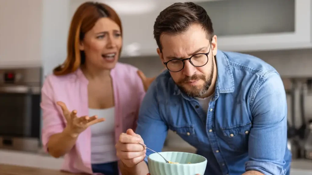 A couple sitting at a kitchen table with tea, engaged in a calm and open conversation about health.