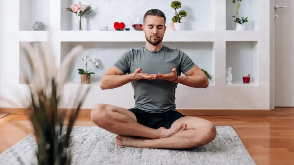 Man practicing diaphragmatic breathing technique for premature ejaculation treatment showing proper posture and breathing mechanics