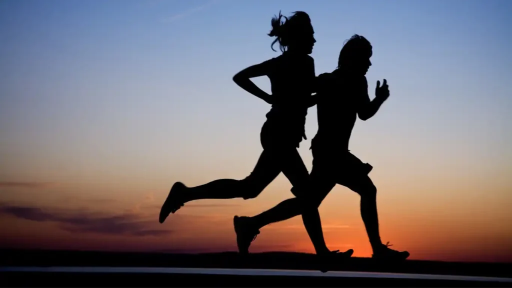 Silhouette of a man running with a highlighted circulatory system to demonstrate the benefits of cardio.